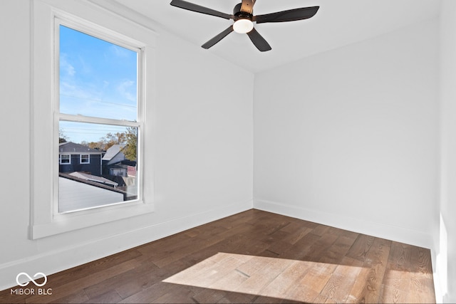 spare room with dark hardwood / wood-style floors and ceiling fan