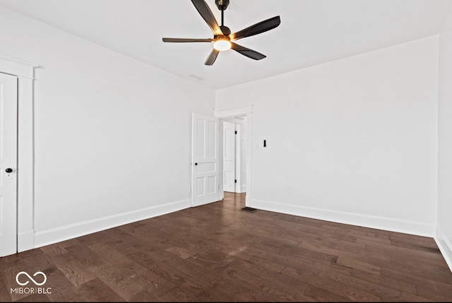 unfurnished room with dark hardwood / wood-style floors and ceiling fan