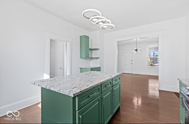 kitchen with green cabinetry, a center island, dark hardwood / wood-style flooring, decorative light fixtures, and a chandelier