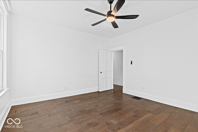 empty room featuring dark hardwood / wood-style floors and ceiling fan