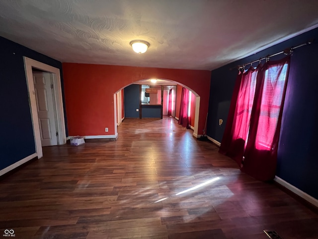 unfurnished room featuring dark wood-type flooring