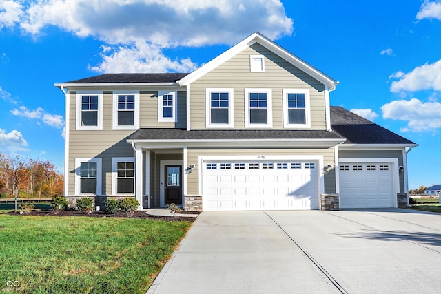 view of front facade featuring a front yard and a garage