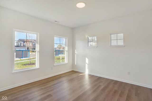 unfurnished room with wood-type flooring