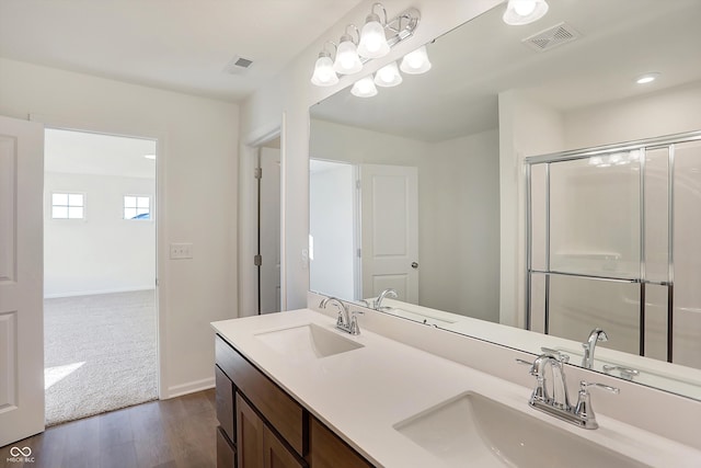 bathroom with vanity, hardwood / wood-style flooring, and an enclosed shower