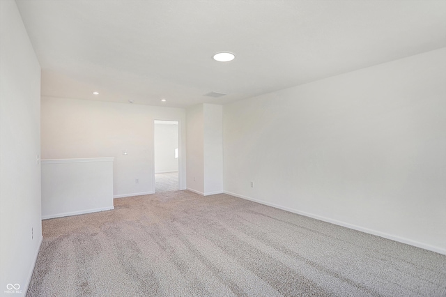 empty room featuring light carpet