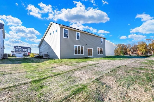 back of house featuring a yard and central AC unit