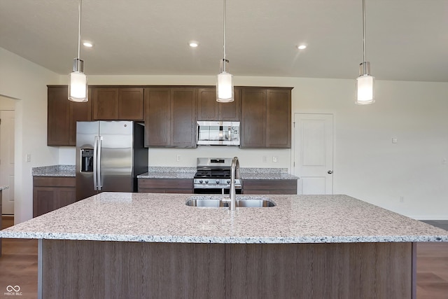 kitchen featuring sink, decorative light fixtures, and stainless steel appliances