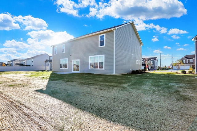 back of property featuring a yard