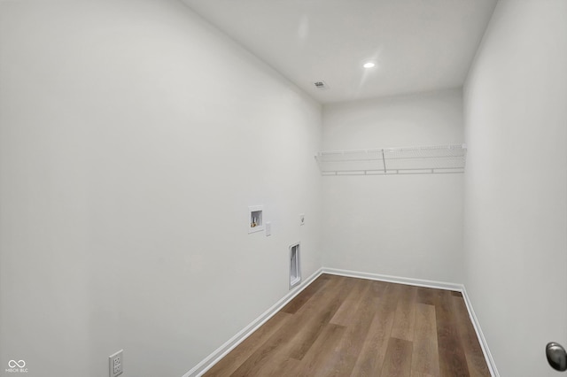 clothes washing area featuring hookup for a washing machine, hookup for an electric dryer, and hardwood / wood-style floors