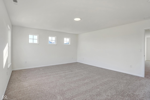 carpeted spare room with a wealth of natural light