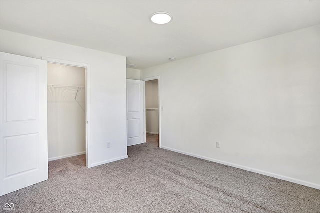 unfurnished bedroom featuring carpet and a closet