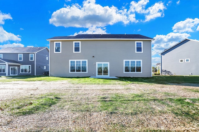 back of house featuring a yard