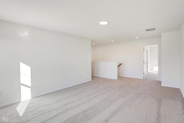 unfurnished room with light colored carpet