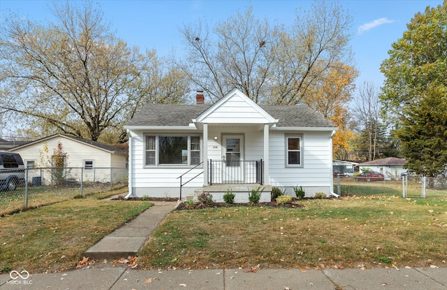 bungalow-style house featuring a front lawn and covered porch