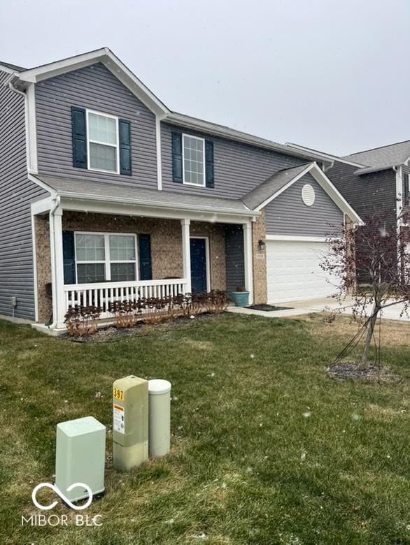 view of front facade featuring a porch, a garage, and a front lawn