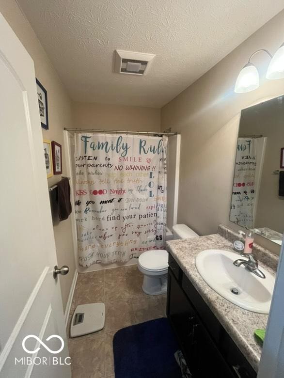 bathroom featuring walk in shower, vanity, a textured ceiling, and toilet