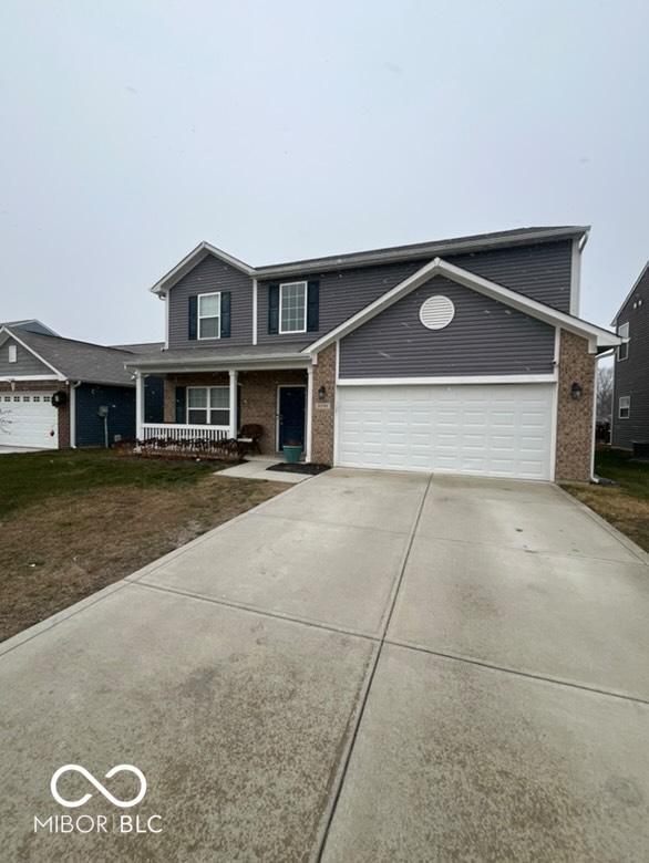 front of property with a porch and a garage