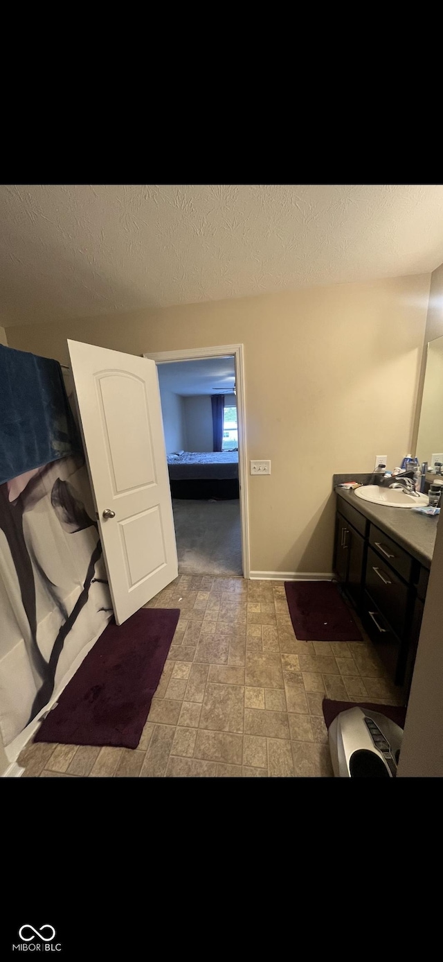 bathroom with vanity and a textured ceiling