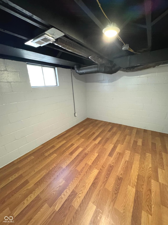 basement with hardwood / wood-style flooring