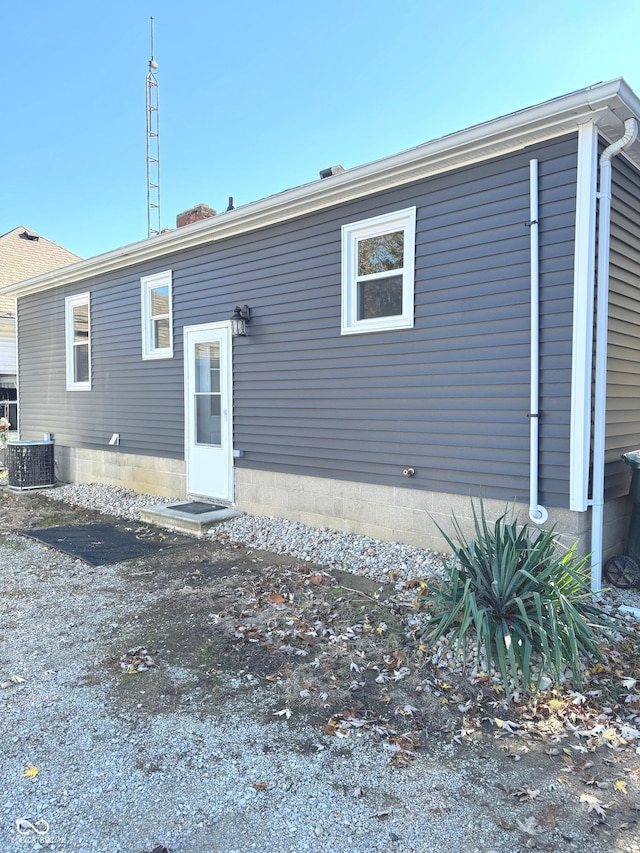 rear view of property with central AC unit