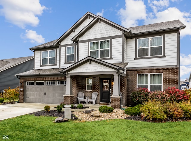 craftsman inspired home with a porch, a garage, and a front lawn