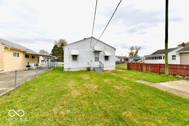 rear view of property with a yard