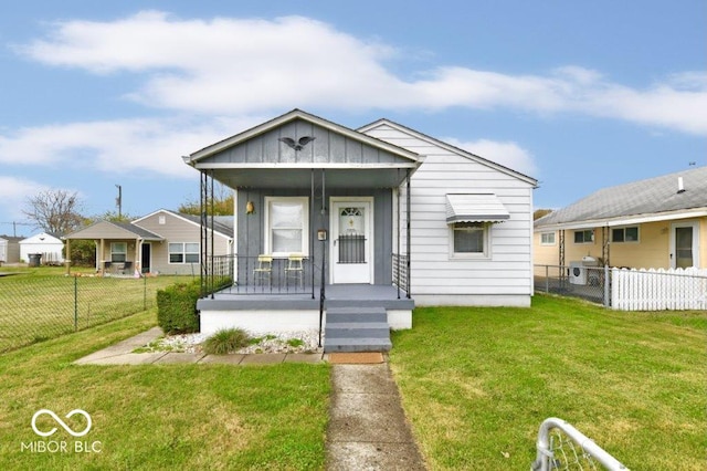 bungalow-style home with a front yard and covered porch