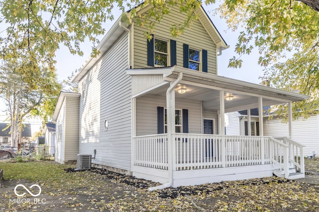 view of front facade featuring central AC unit and a porch