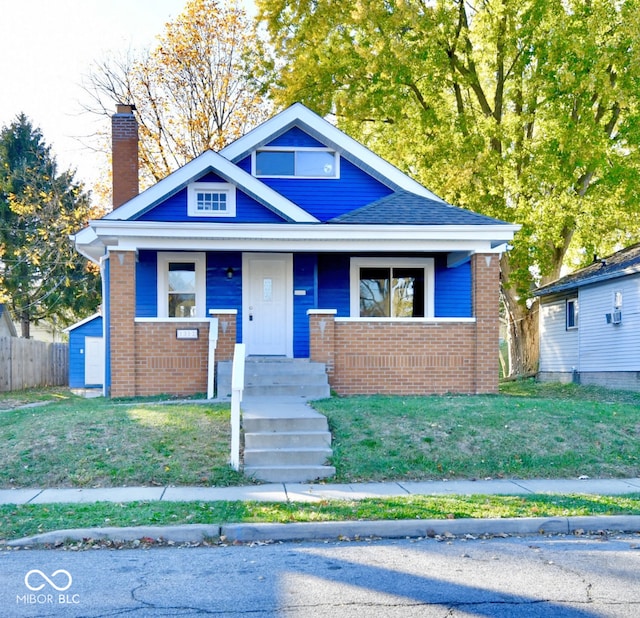 bungalow featuring a front lawn and covered porch