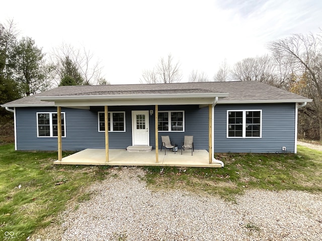 rear view of property with a lawn and a patio area