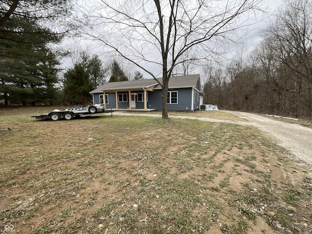 view of front of home with a porch and a front lawn