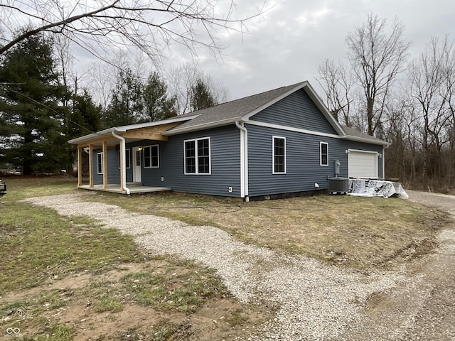 view of home's exterior featuring a garage and a porch