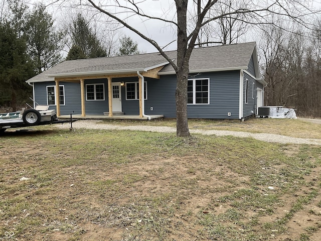 ranch-style house with central AC, covered porch, and a front lawn