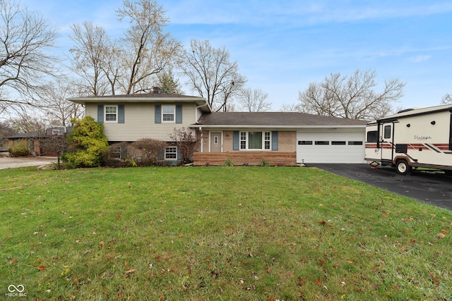 split level home featuring a garage and a front lawn