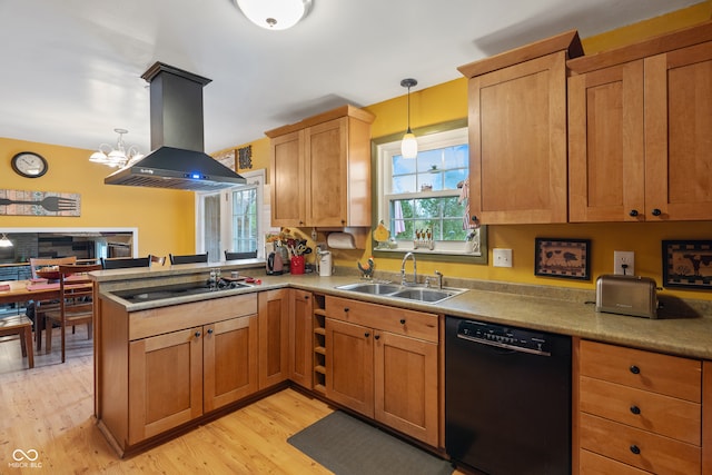 kitchen with island range hood, pendant lighting, light hardwood / wood-style flooring, black dishwasher, and stainless steel gas stovetop