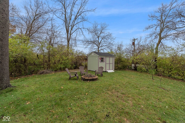 view of yard with a storage shed and an outdoor fire pit