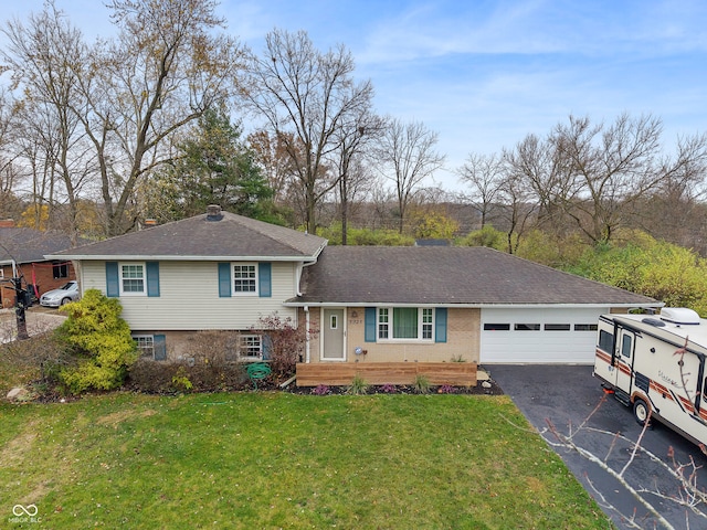 tri-level home featuring a front yard and a garage