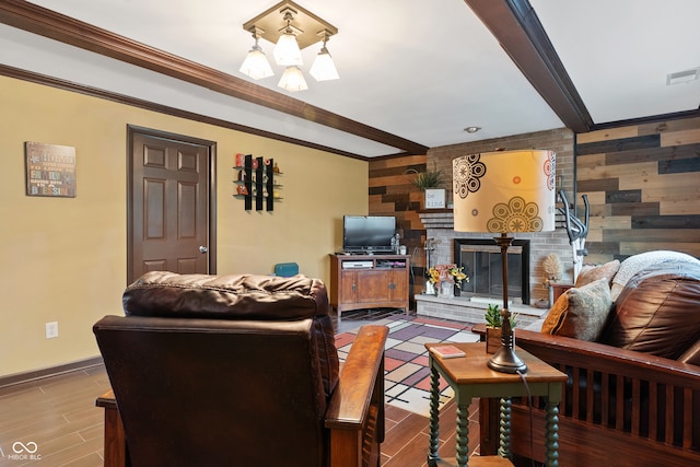 living room with beam ceiling, a brick fireplace, wooden walls, and hardwood / wood-style floors