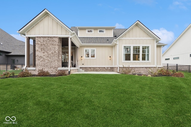 rear view of house featuring a yard