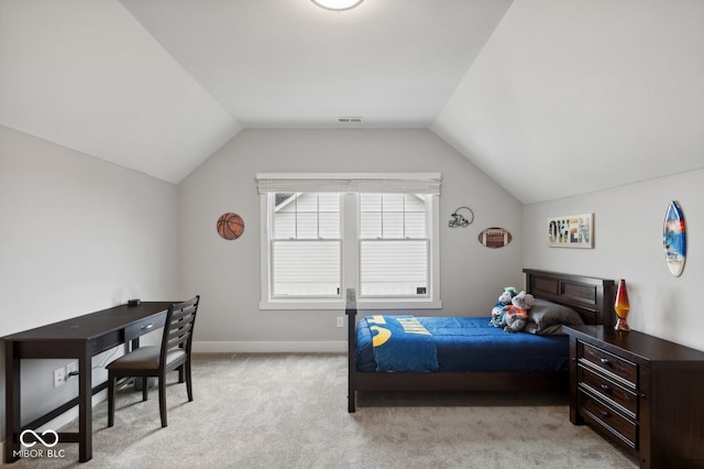 carpeted bedroom with lofted ceiling