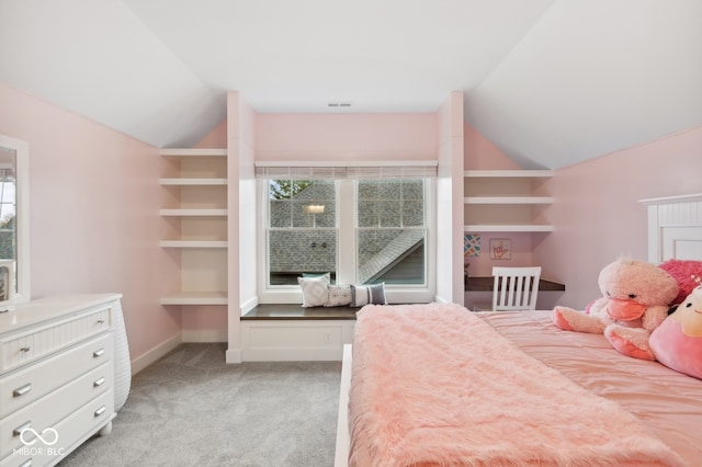 bedroom with lofted ceiling, multiple windows, and light carpet