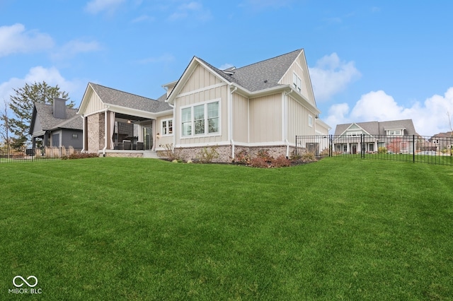 back of house with a lawn and a patio