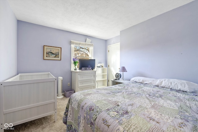 bedroom featuring light colored carpet and a textured ceiling