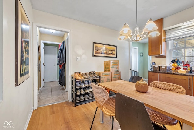 dining room with light hardwood / wood-style floors and a chandelier