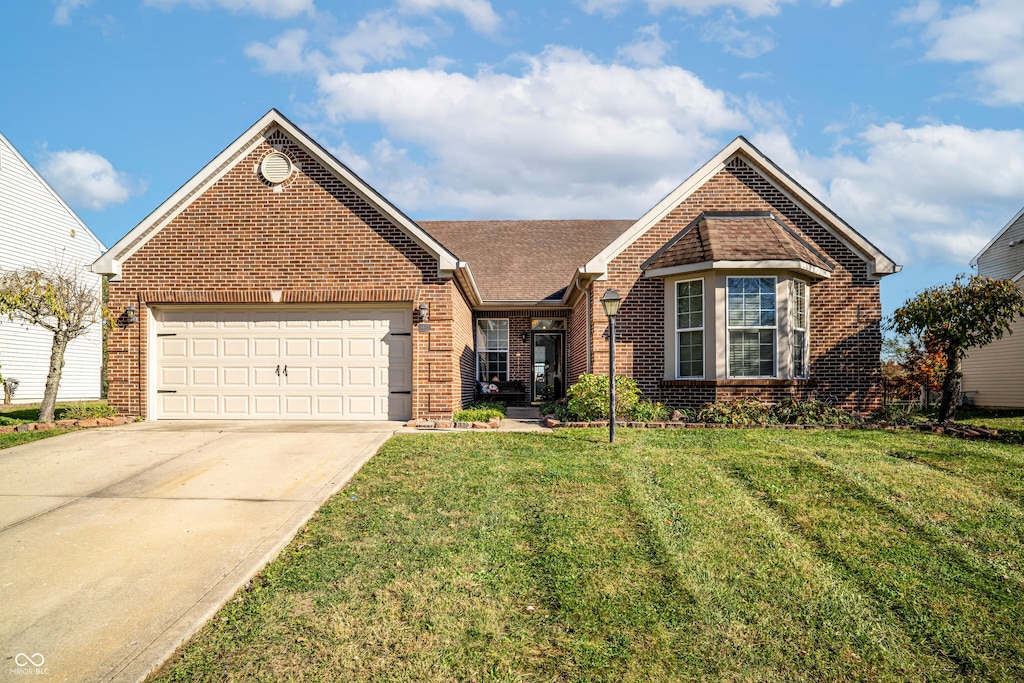 view of front of home with a garage and a front yard