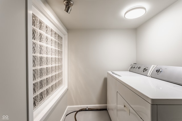 laundry room featuring washing machine and clothes dryer