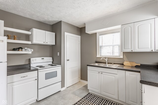 kitchen featuring a textured ceiling, white cabinetry, white appliances, and sink