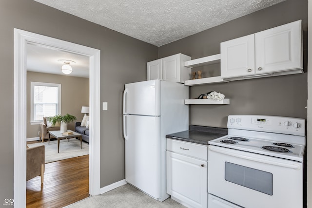 kitchen with a textured ceiling, white cabinetry, white appliances, and light wood-type flooring