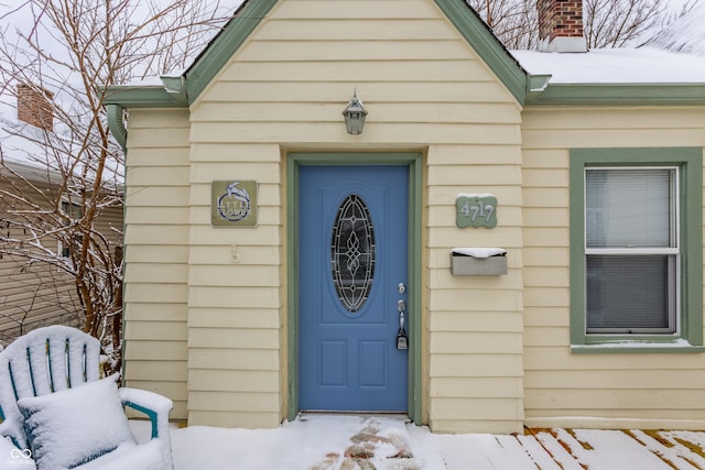 view of snow covered property entrance