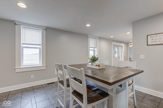 tiled dining room with plenty of natural light